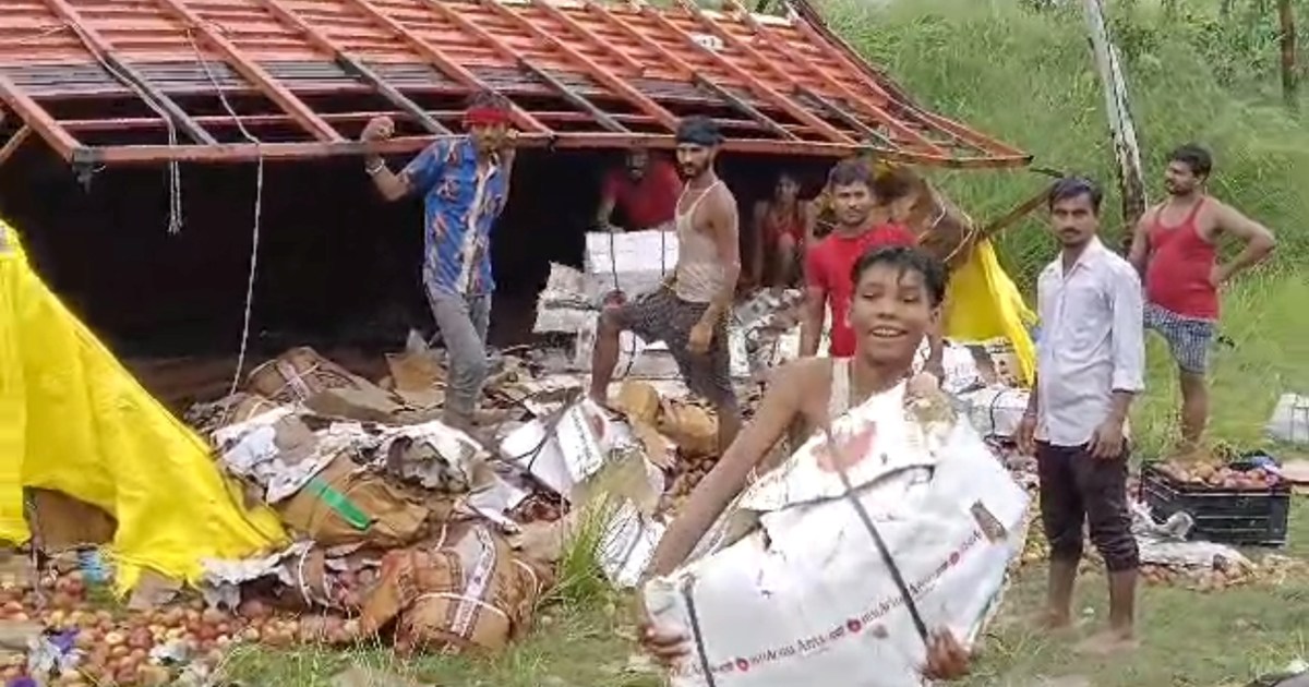  Truck laden with boxes of apples overturned
