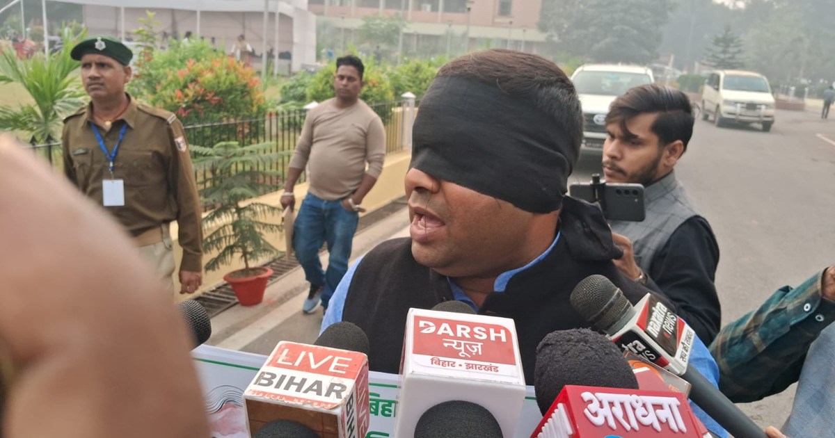 RJD MLA Mukesh Roshan is blindfolded and has a placard in hi